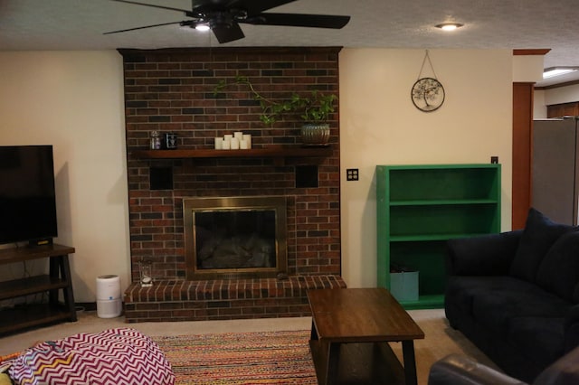 carpeted living area featuring ceiling fan, a textured ceiling, and a fireplace