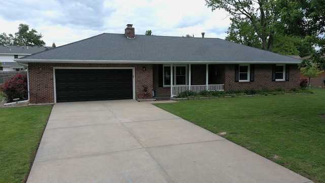 ranch-style house featuring covered porch, an attached garage, brick siding, and a front lawn