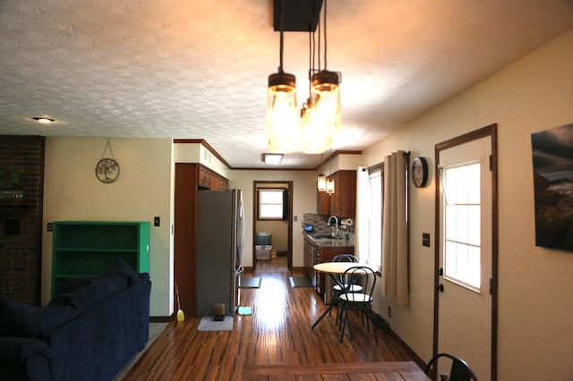dining area with dark wood-style flooring and baseboards