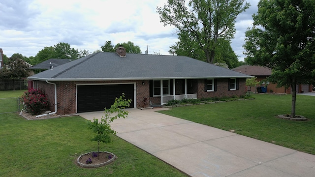 ranch-style home with an attached garage, driveway, a chimney, brick siding, and covered porch