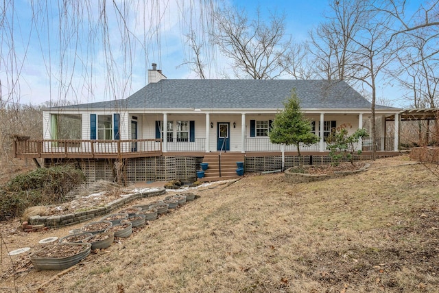 70 Roseville Dr, Rogersville, MO 65742 - view of front of house featuring covered porch, a chimney, a shingled roof, and a front yard