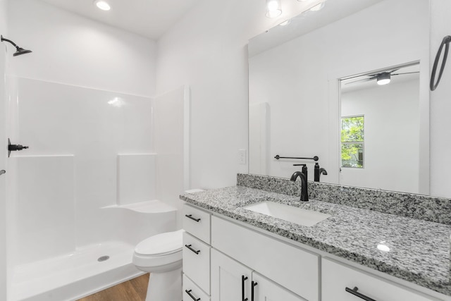 303 W Odell St, Marionville, MO 65705 - bathroom featuring wood finished floors, a shower, toilet, and vanity