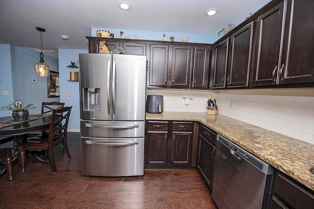 824 E Crystal Ave, Nixa, MO 65714 - kitchen with stainless steel appliances, dark brown cabinetry, light stone countertops, and recessed lighting