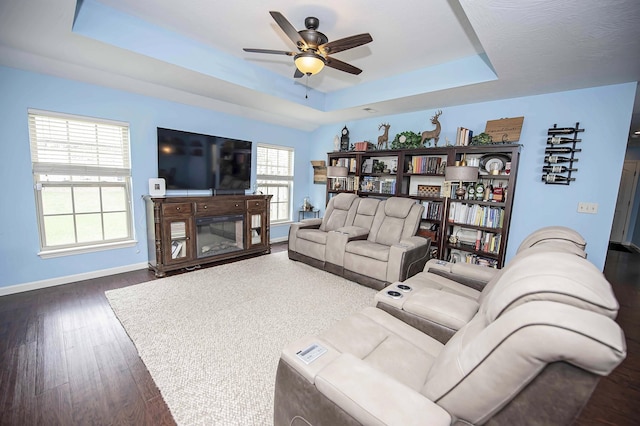 824 E Crystal Ave, Nixa, MO 65714 - living area featuring a tray ceiling, ceiling fan, baseboards, and wood finished floors