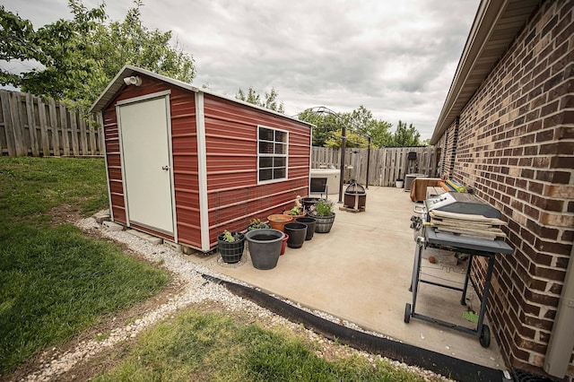 824 E Crystal Ave, Nixa, MO 65714 - view of patio with a fenced backyard, an outdoor structure, and a shed