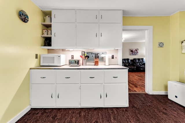 274 Beach Blvd, Rockaway Beach, MO 65740 - kitchen with white microwave, dark wood-style floors, open shelves, white cabinets, and baseboards