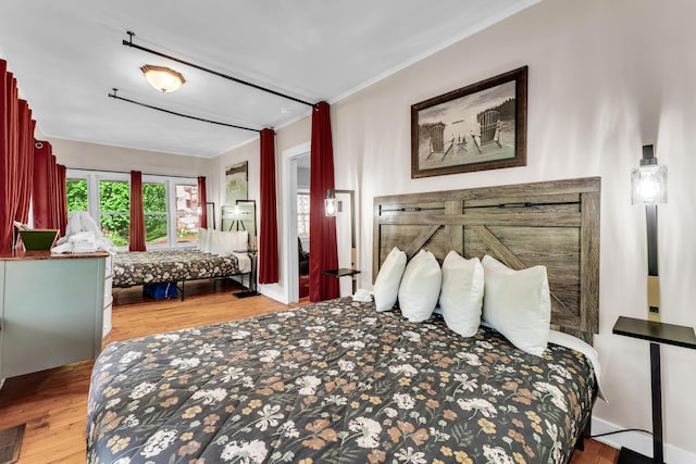 274 Beach Blvd, Rockaway Beach, MO 65740 - bedroom with wood finished floors and crown molding