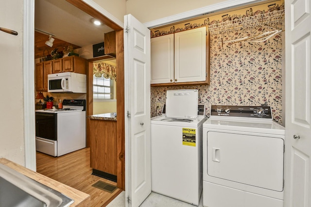 147 Liberty Ln, Kimberling City, MO 65686 - washroom with cabinet space, separate washer and dryer, and light wood-style flooring