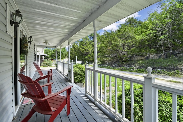 147 Liberty Ln, Kimberling City, MO 65686 - wooden deck featuring covered porch, view of scattered trees, and a ceiling fan