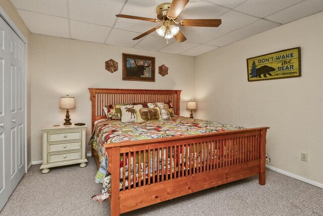 147 Liberty Ln, Kimberling City, MO 65686 - bedroom with carpet floors, a paneled ceiling, baseboards, a closet, and ceiling fan