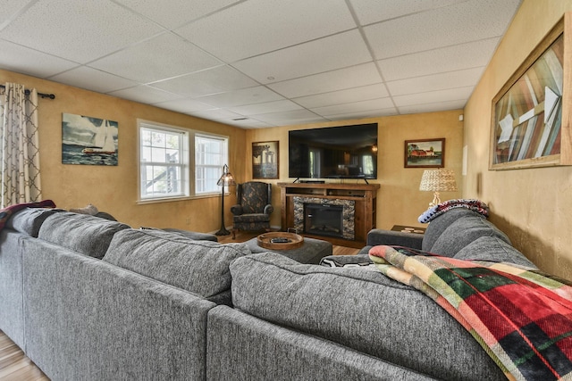147 Liberty Ln, Kimberling City, MO 65686 - living area featuring a paneled ceiling, a fireplace, and wood finished floors