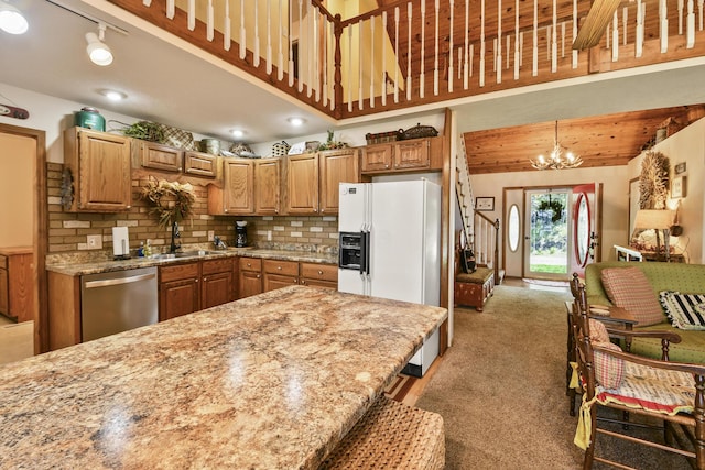 147 Liberty Ln, Kimberling City, MO 65686 - kitchen with stainless steel dishwasher, white refrigerator with ice dispenser, a sink, light colored carpet, and a chandelier