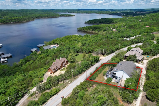 147 Liberty Ln, Kimberling City, MO 65686 - aerial overview of property's location with a heavily wooded area, property boundaries highlighted, and a nearby body of water