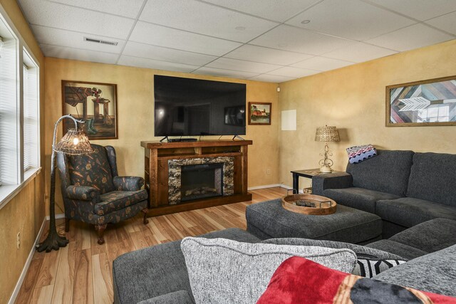 147 Liberty Ln, Kimberling City, MO 65686 - living area featuring a drop ceiling, wood finished floors, baseboards, and a high end fireplace