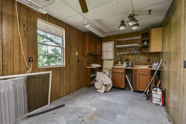 147 Liberty Ln, Kimberling City, MO 65686 - kitchen with open shelves, brown cabinets, wooden walls, concrete floors, and light countertops