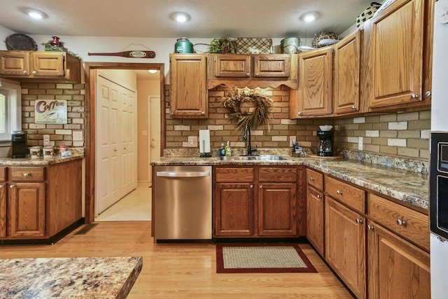 147 Liberty Ln, Kimberling City, MO 65686 - kitchen with dishwasher, a sink, light wood-type flooring, backsplash, and a textured ceiling