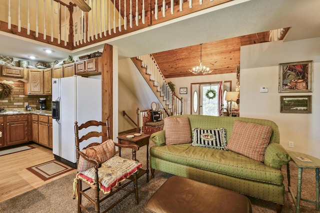 147 Liberty Ln, Kimberling City, MO 65686 - living area with stairway, a chandelier, light colored carpet, light wood-style floors, and a high ceiling