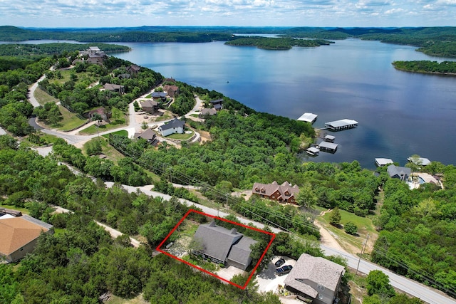 147 Liberty Ln, Kimberling City, MO 65686 - aerial view of residential area featuring a nearby body of water, property boundaries highlighted, and a heavily wooded area