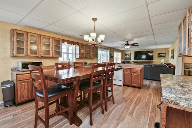 147 Liberty Ln, Kimberling City, MO 65686 - dining space with a paneled ceiling, light wood finished floors, a chandelier, and a ceiling fan