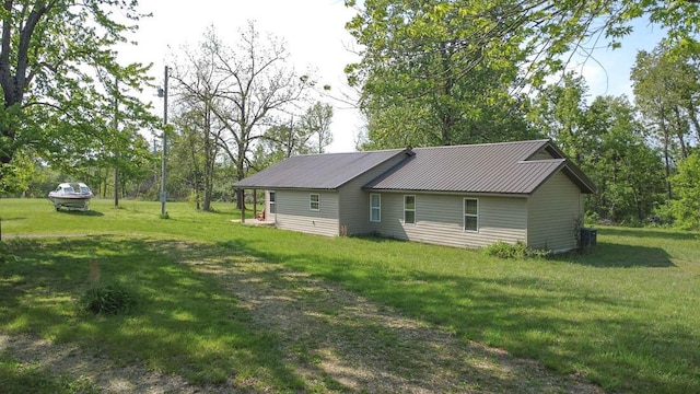 468 Martingale Dr, Theodosia, MO 65761 - back of house with a lawn and metal roof