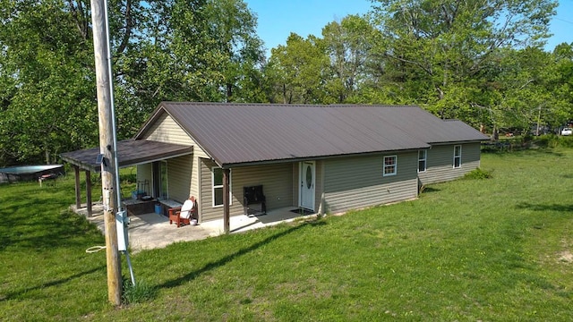468 Martingale Dr, Theodosia, MO 65761 - rear view of house featuring a patio, a lawn, and metal roof