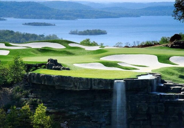 view of community with a water and mountain view and view of golf course