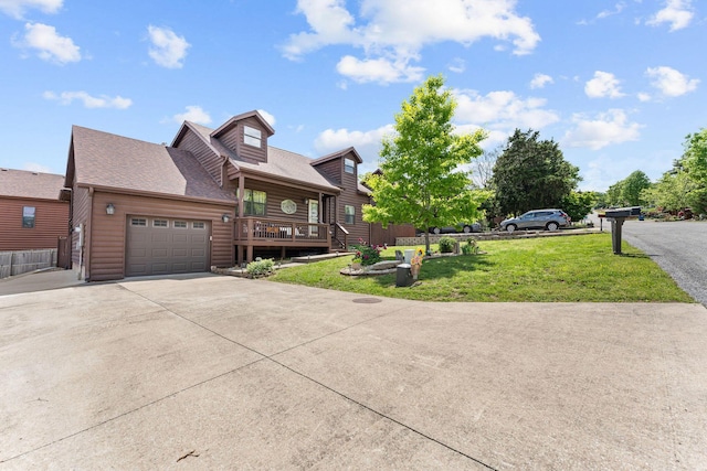 view of front of house with a front lawn, driveway, a garage, roof with shingles, and covered porch