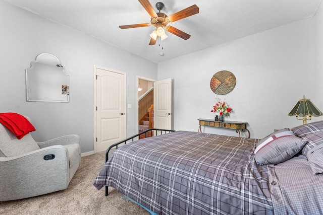 carpeted bedroom with a ceiling fan and baseboards
