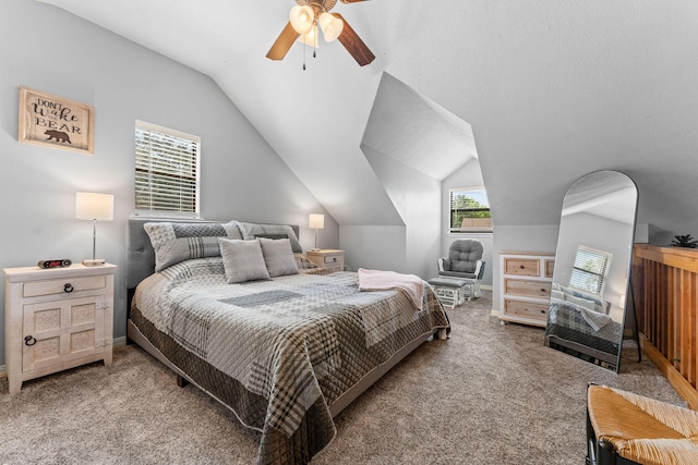bedroom with carpet flooring, vaulted ceiling, baseboards, and a ceiling fan