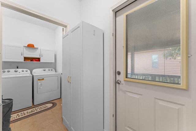 laundry room featuring cabinet space, independent washer and dryer, and light tile patterned floors