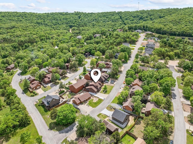 aerial view of residential area featuring a heavily wooded area