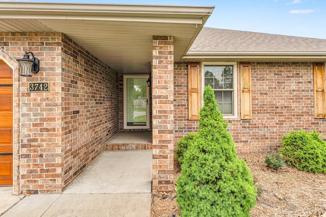 3742 W Village Ter, Springfield, MO 65810 - property entrance with a shingled roof and brick siding
