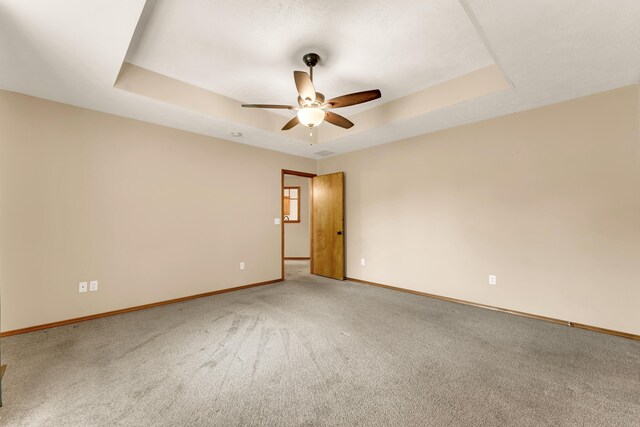 3742 W Village Ter, Springfield, MO 65810 - carpeted empty room with ceiling fan, a tray ceiling, and baseboards