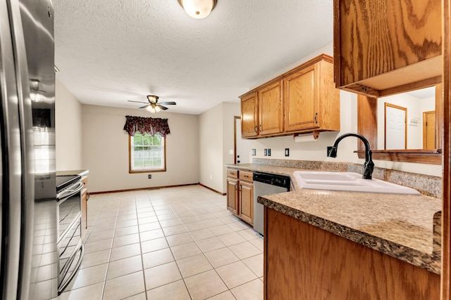 3742 W Village Ter, Springfield, MO 65810 - kitchen with stainless steel appliances, a sink, ceiling fan, brown cabinets, and baseboards