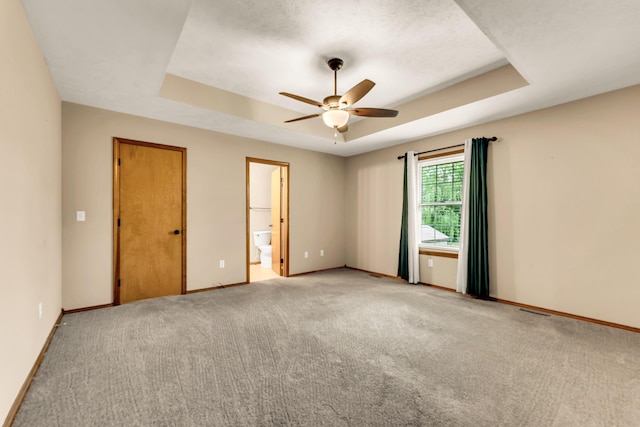 3742 W Village Ter, Springfield, MO 65810 - empty room with a tray ceiling, a ceiling fan, baseboards, and light carpet