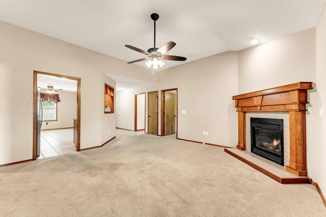 3742 W Village Ter, Springfield, MO 65810 - unfurnished living room featuring ceiling fan, carpet floors, a tile fireplace, and baseboards