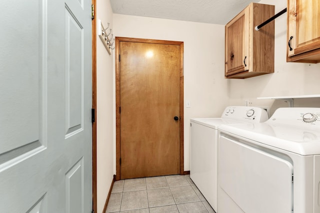 3742 W Village Ter, Springfield, MO 65810 - laundry area with cabinet space, washer and clothes dryer, and light tile patterned floors