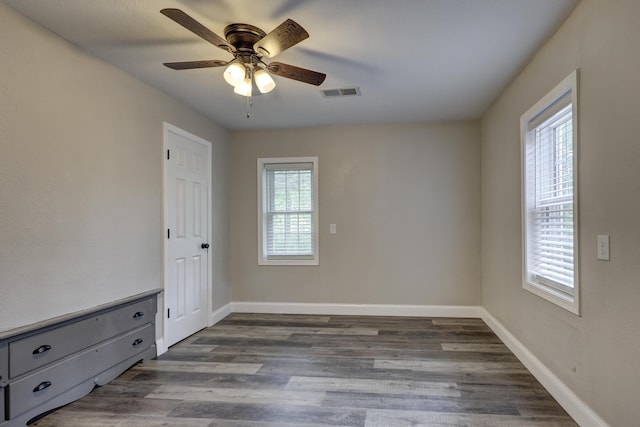 unfurnished bedroom featuring wood finished floors, baseboards, and ceiling fan