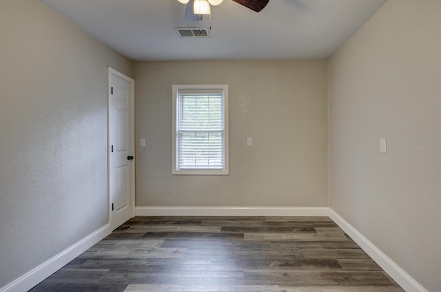 spare room featuring ceiling fan, wood finished floors, and baseboards