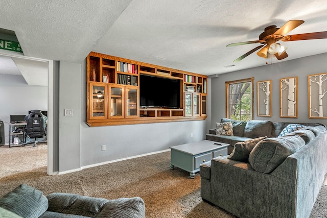 living room featuring carpet floors, ceiling fan, a textured ceiling, and a desk