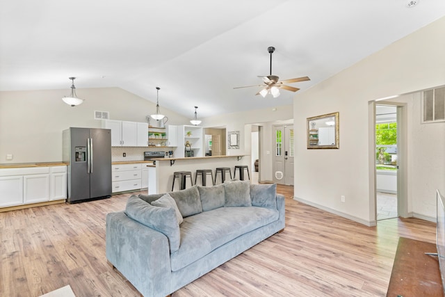 245 Country Hills Rd, Branson, MO 65616 - living room with vaulted ceiling, a ceiling fan, light wood finished floors, and baseboards