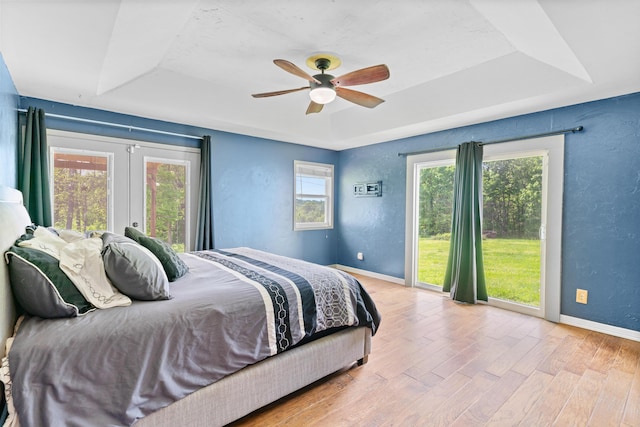 245 Country Hills Rd, Branson, MO 65616 - bedroom with a raised ceiling, baseboards, wood finished floors, ceiling fan, and french doors