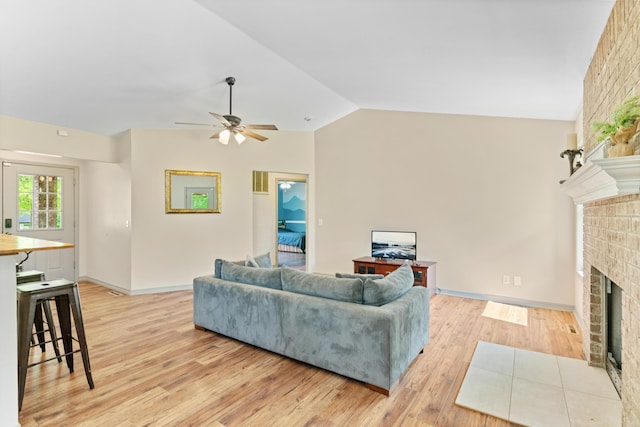245 Country Hills Rd, Branson, MO 65616 - living area featuring a brick fireplace, light wood finished floors, lofted ceiling, a ceiling fan, and baseboards