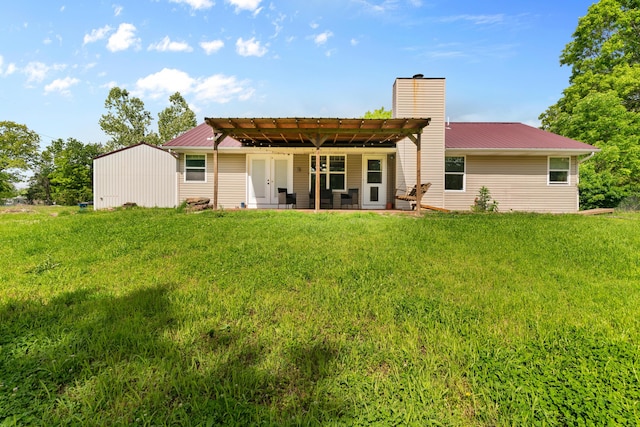 245 Country Hills Rd, Branson, MO 65616 - back of property with a chimney, metal roof, a pergola, and a lawn