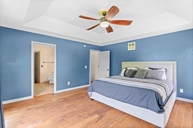 245 Country Hills Rd, Branson, MO 65616 - bedroom with a raised ceiling, wood finished floors, baseboards, connected bathroom, and a ceiling fan