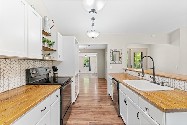 245 Country Hills Rd, Branson, MO 65616 - kitchen featuring black range with electric stovetop, a sink, dishwashing machine, and butcher block counters