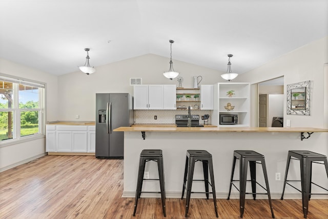 245 Country Hills Rd, Branson, MO 65616 - kitchen with wooden counters, appliances with stainless steel finishes, open shelves, a breakfast bar area, and lofted ceiling