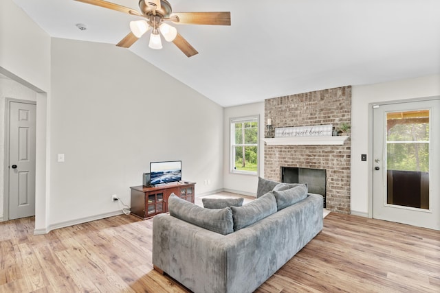 245 Country Hills Rd, Branson, MO 65616 - living room with light wood-type flooring, vaulted ceiling, a ceiling fan, a fireplace, and baseboards