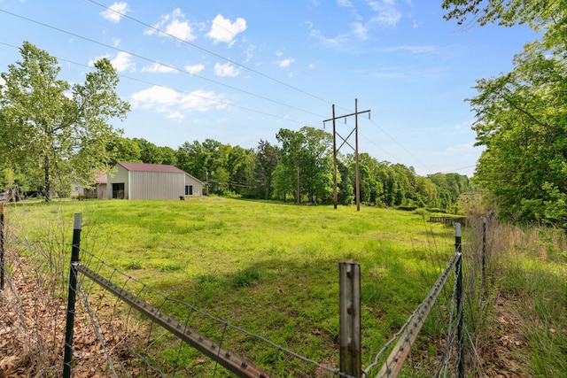 245 Country Hills Rd, Branson, MO 65616 - view of yard featuring an outbuilding, an outdoor structure, fence, and a view of trees