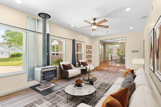 245 Country Hills Rd, Branson, MO 65616 - living room featuring a wood stove, wood finished floors, ceiling fan, recessed lighting, and a chandelier
